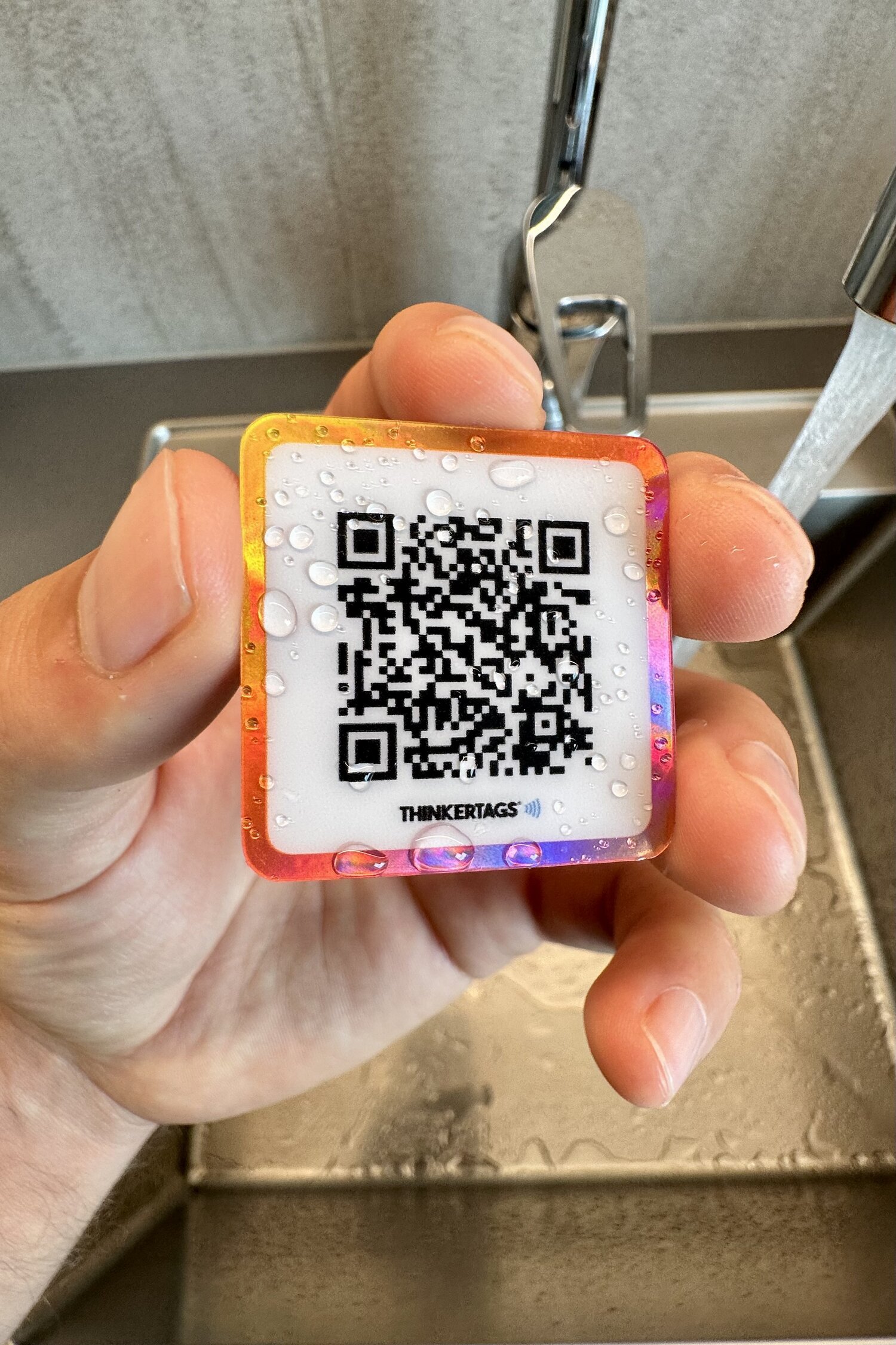 Waterproof Google review sticker held under running water